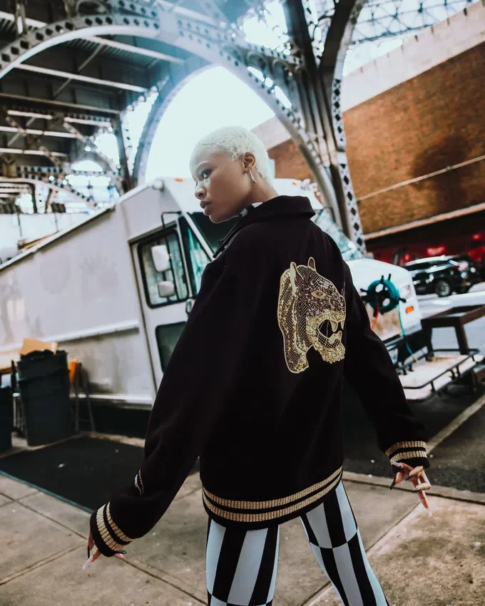 A.I.9 AFRICAN INTELLIGENCE GUILDED LEOPARD – SANDFLOWER COLLAB VARSITY-JACKE